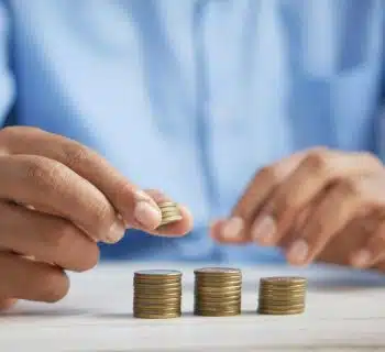 a person stacking coins on top of a table